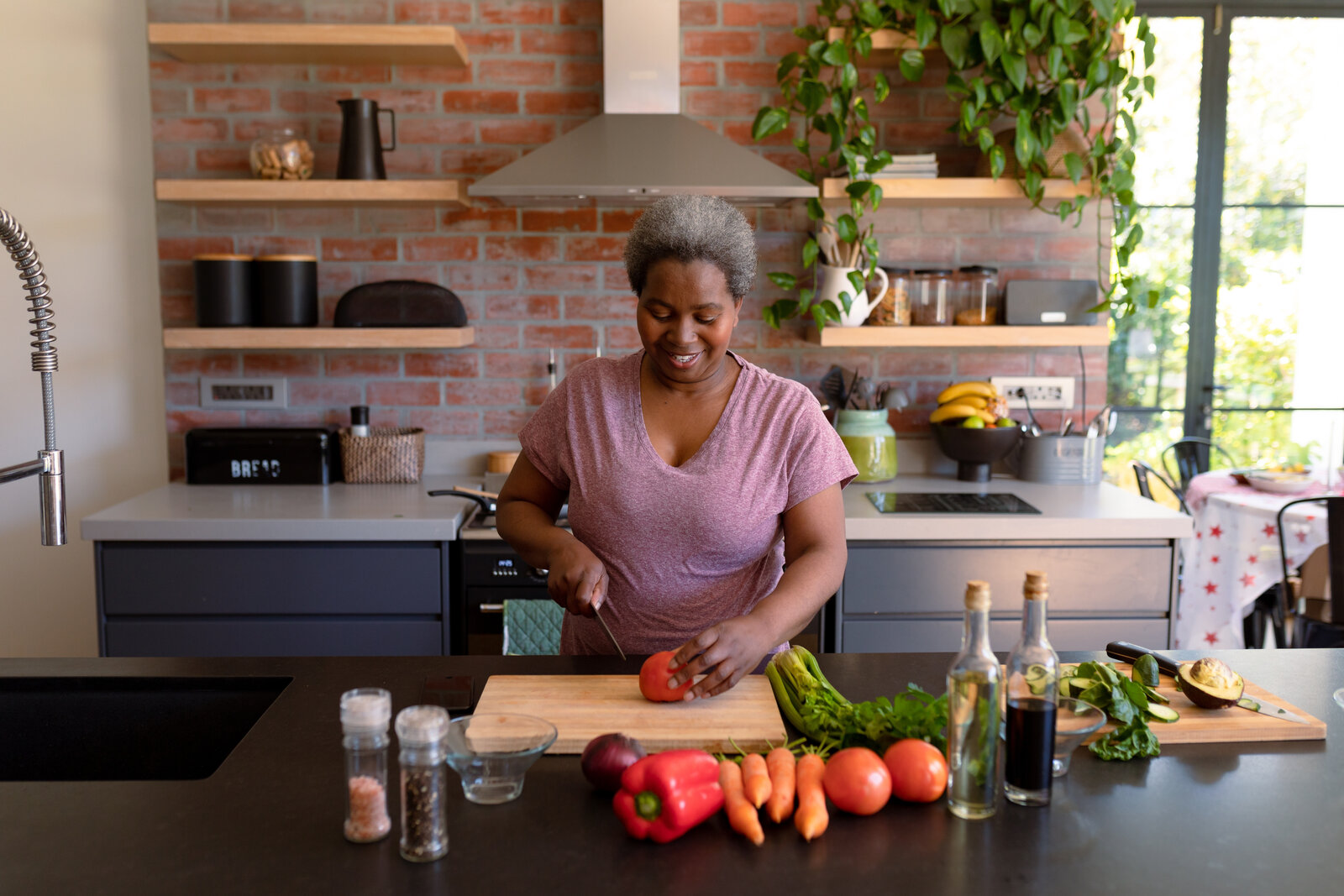 A companion preparing a fresh, home-cooked meal in the kitchen
